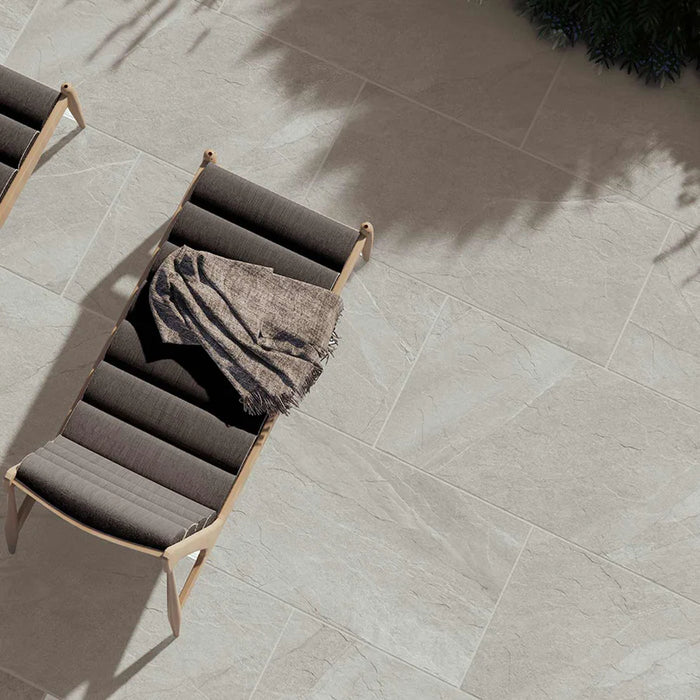 Outdoor Porcelain tile 60x120cm Hailes Taupe patio with brown sun loungers on it.