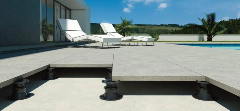 Image of 20mm tiles sat on top of plastic pedestals with deck chairs