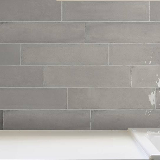 laurel grey wall tiles as a kitchen splash back with tap and sink and fruit bowl on work top