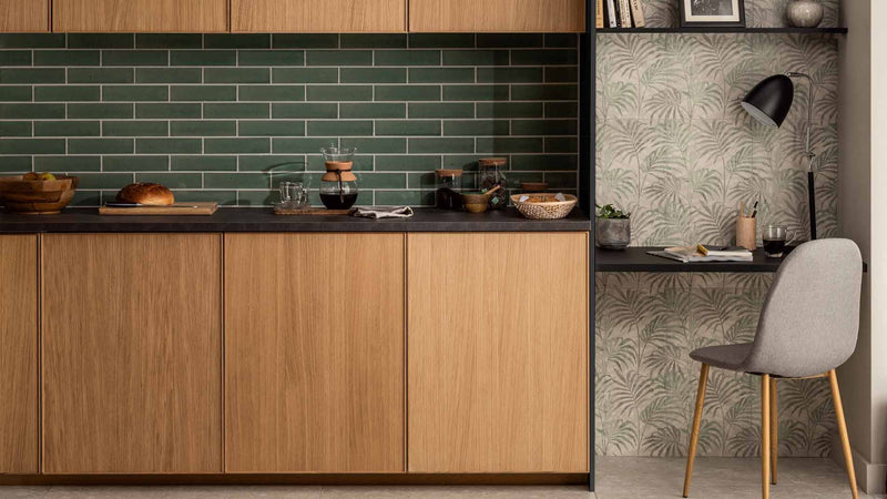 Image of green kitchen tile with wooden cupboards and work space
