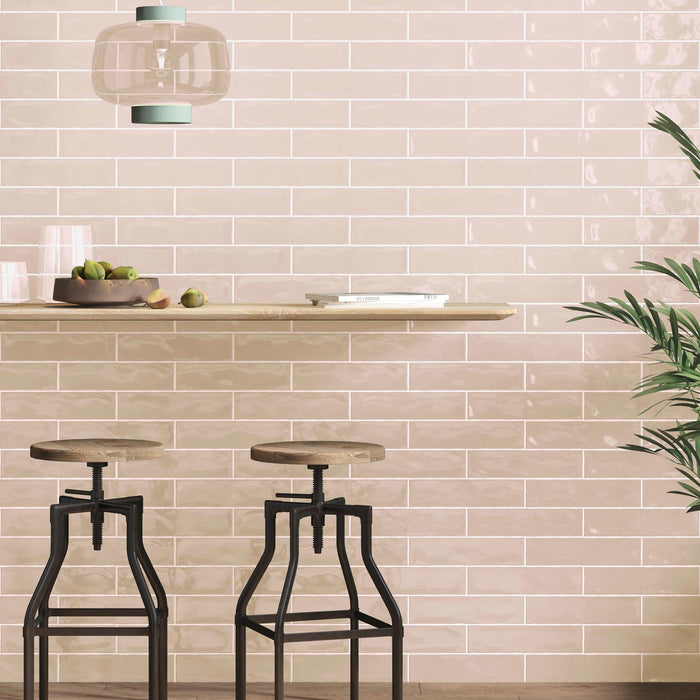 Pink brick wall tiles with a breakfast bar and stools