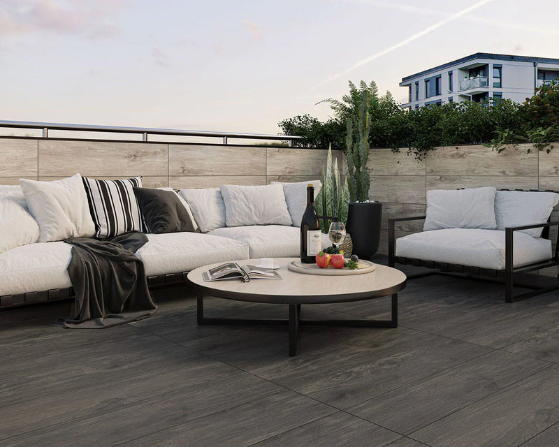 Image of porcelain paving laid with pedestals for paving. Wood effect slabs with outdoor sofa and coffee table