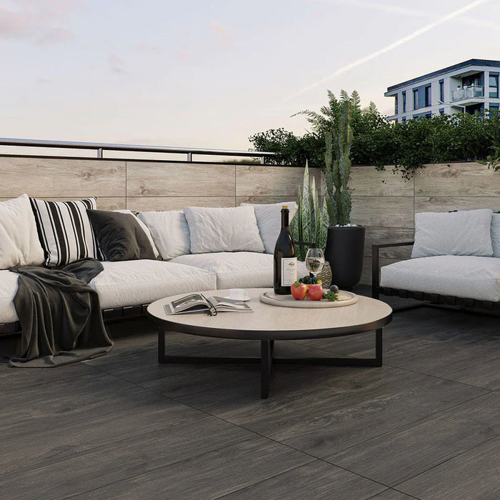 porcelain paving laid with pedestals for paving. Wood effect slabs with outdoor sofa and coffee table