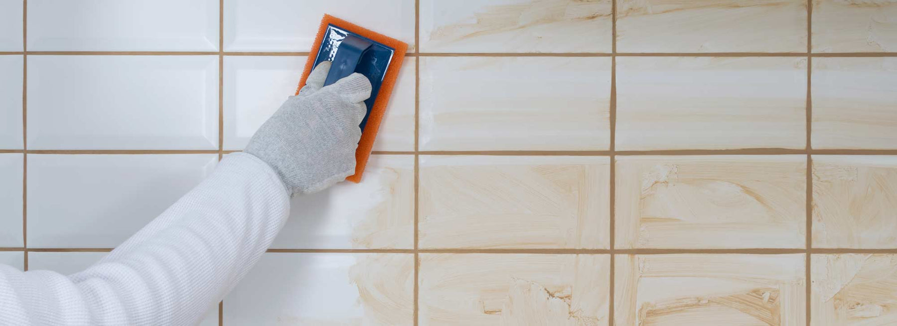 white tiles with beige grout being cleaned off tiles