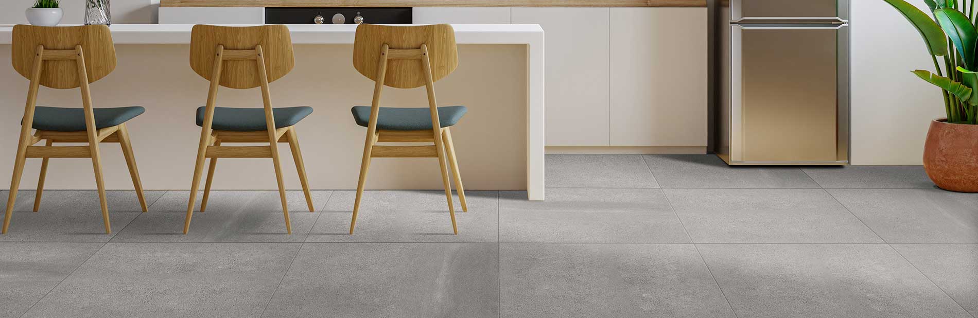 Image of kitchen breakfast bar with wooden chairs and large porcelain tiles 