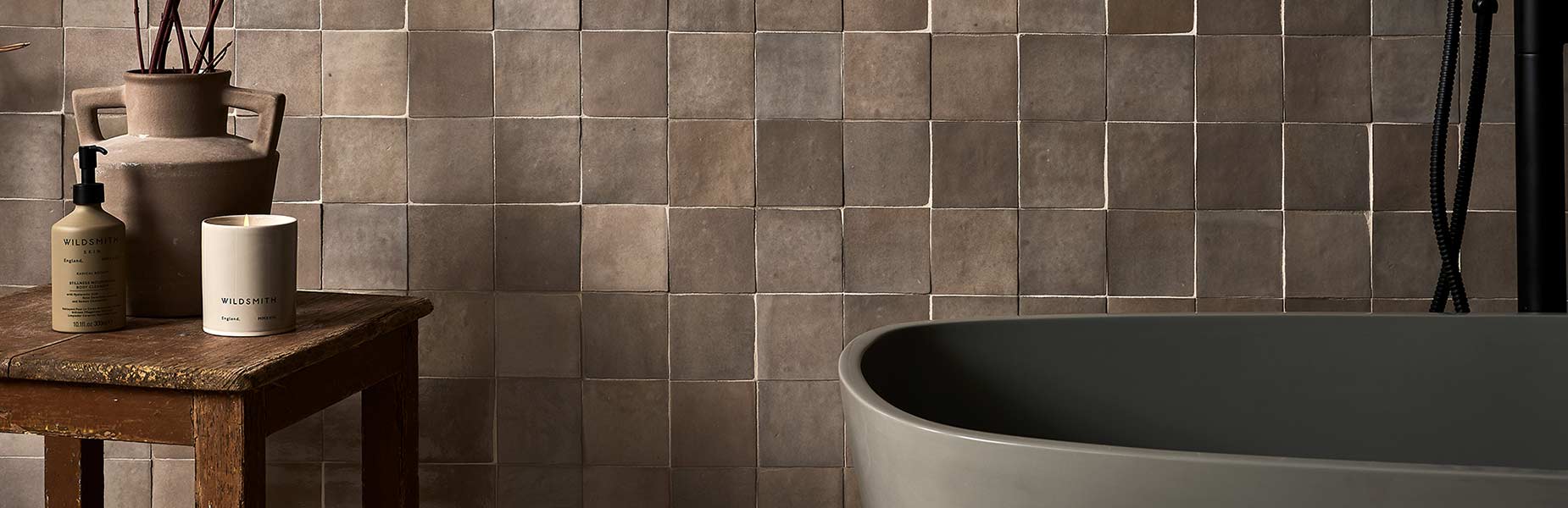 Image of grey bathroom wall tile with free standing bath and side table