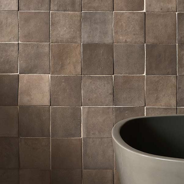 grey bathroom wall tile with free standing bath and side table