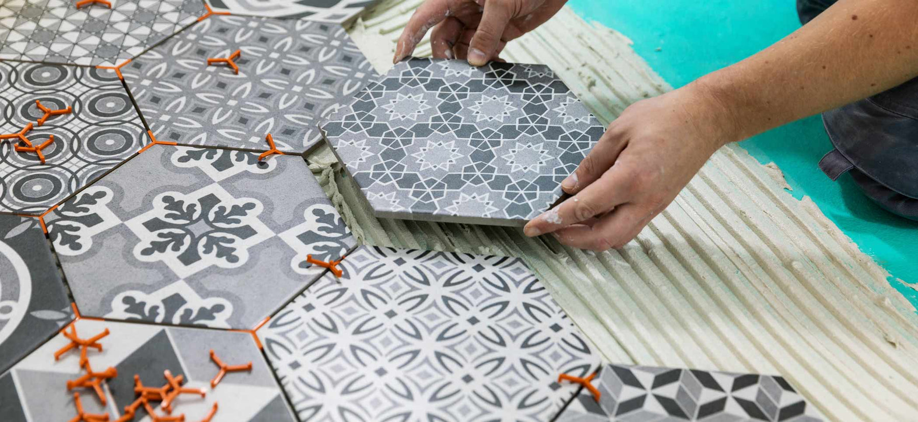 hexagon tiles being fitted on a floor with adhesive