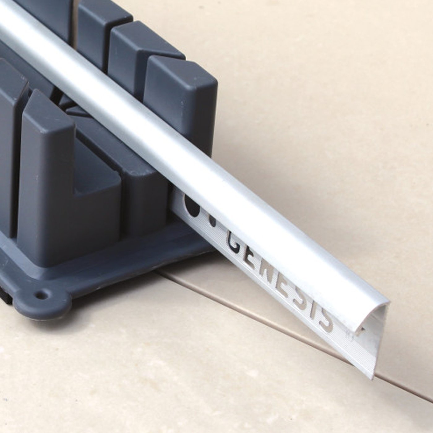 Image of Gray plastic mitre block on a beige surface