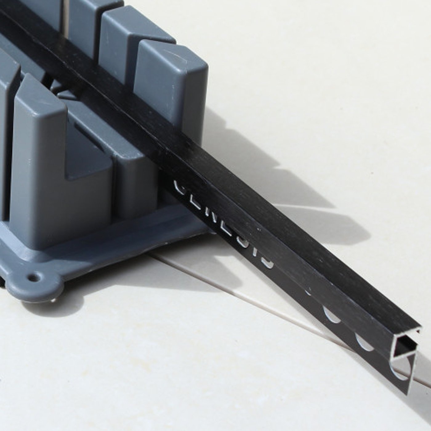 Image of Gray plastic mitre block on a white background