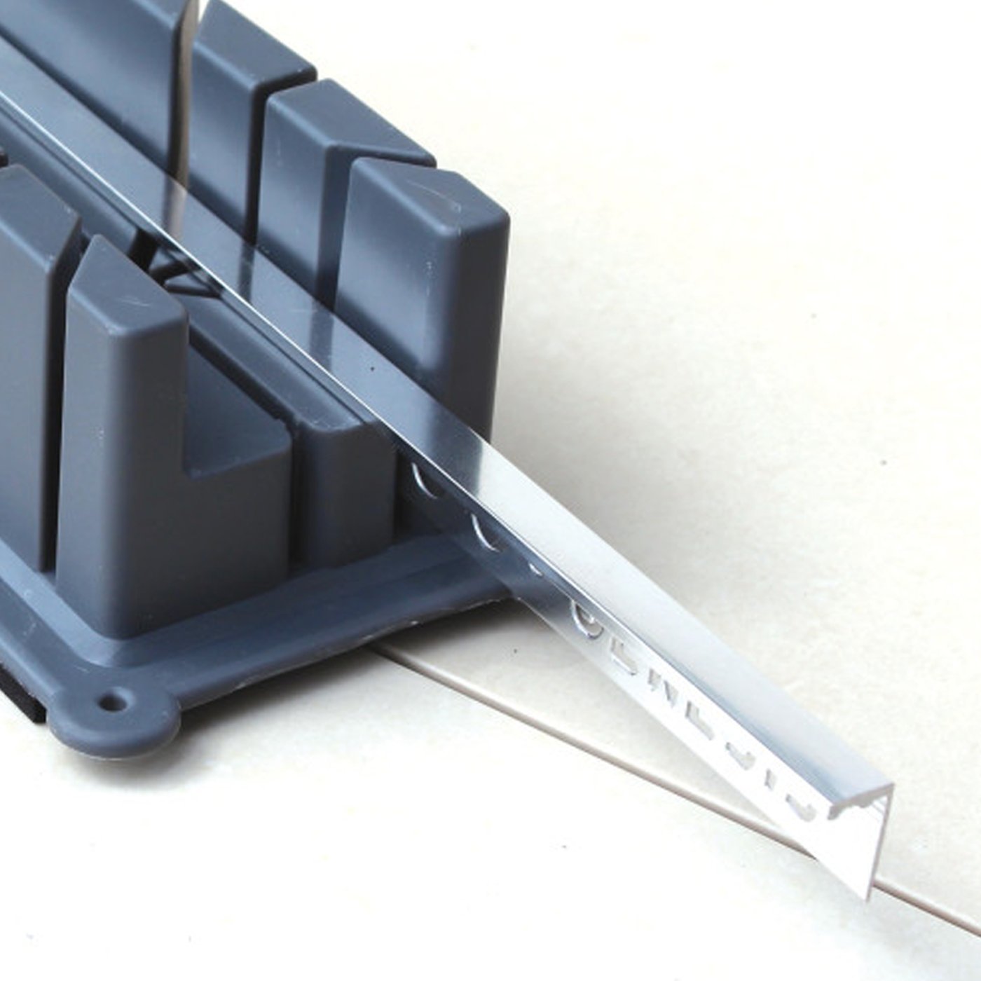 Image of Gray plastic mitre block on a white surface