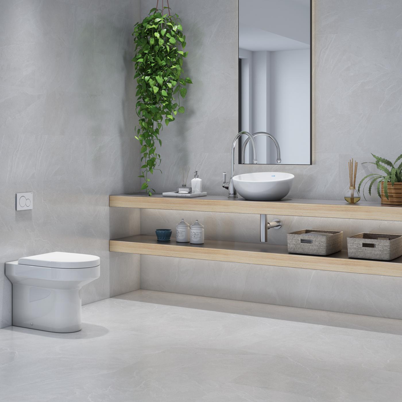 Image of A modern bathroom vanity setup with a white vessel sink, chrome faucet, open wooden shelves, a large wall mirror, gray textured walls and floor, a white toilet, and green plants.
