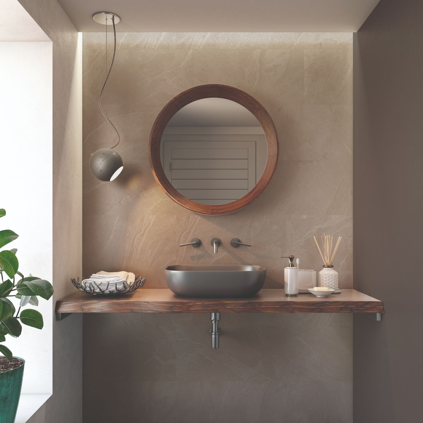 Image of A floating wooden bathroom vanity with a dark gray vessel sink, a round wood-framed mirror, and matching wall-mounted fixtures in a modern minimalist bathroom setting.