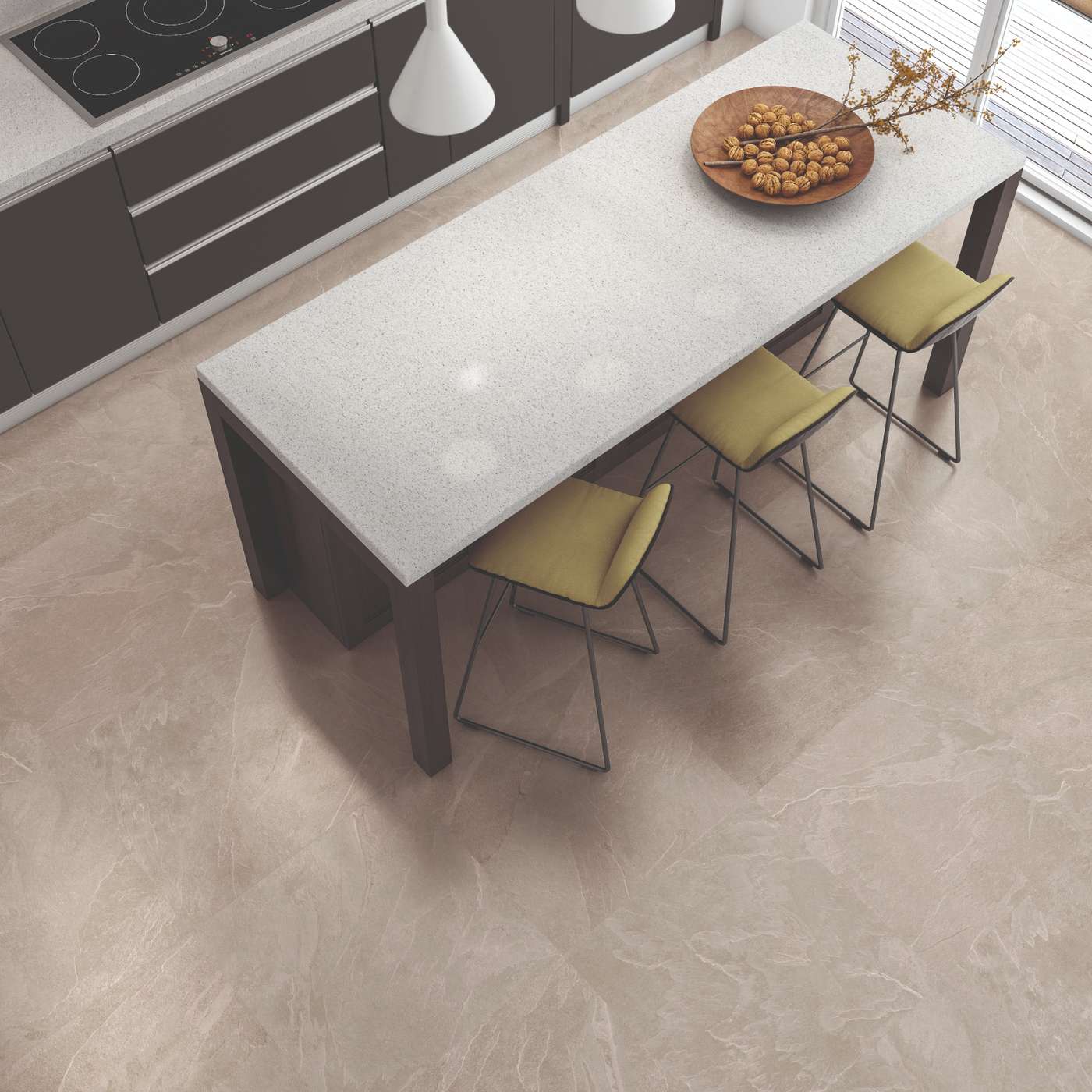 Image of A high-angle view of a modern kitchen featuring light beige marble-look floor tiles, a white stone island table, dark brown cabinetry, and four yellow-green bar stools.