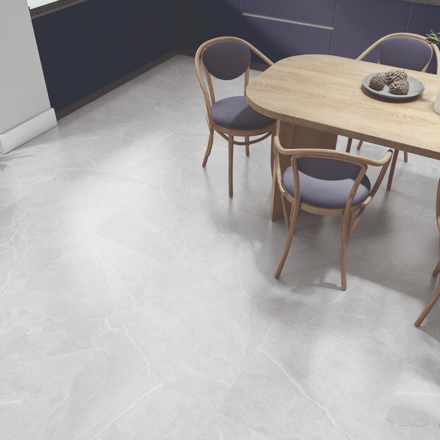 Image of Light gray marble-look floor tiles shown in a modern dining room setting with a wooden dining table and chairs.