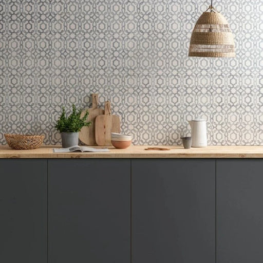 Modern kitchen with wooden countertop, dark cabinets, and patterned wallpaper.