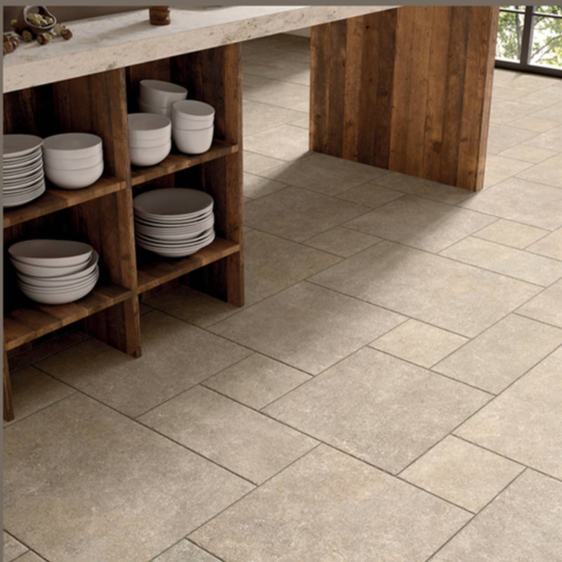 Image of Light beige stone-look rectangular floor tiles installed in a modern kitchen setting with a wooden counter and shelves holding white plates.