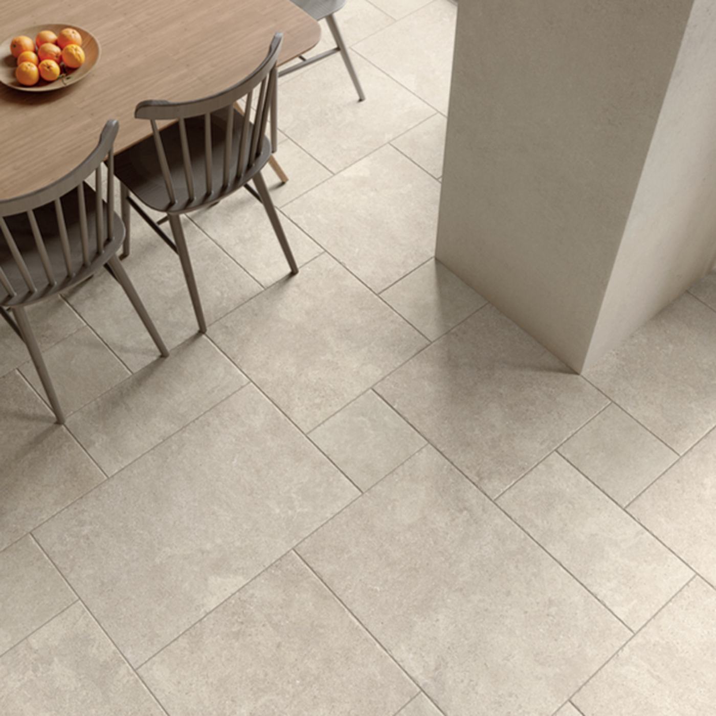 Image of White rectangular floor tiles in a modern dining room setting, shown with a wooden dining table and chairs.