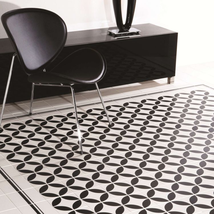 Image of Black and white geometric patterned floor with a black chair and cabinet.