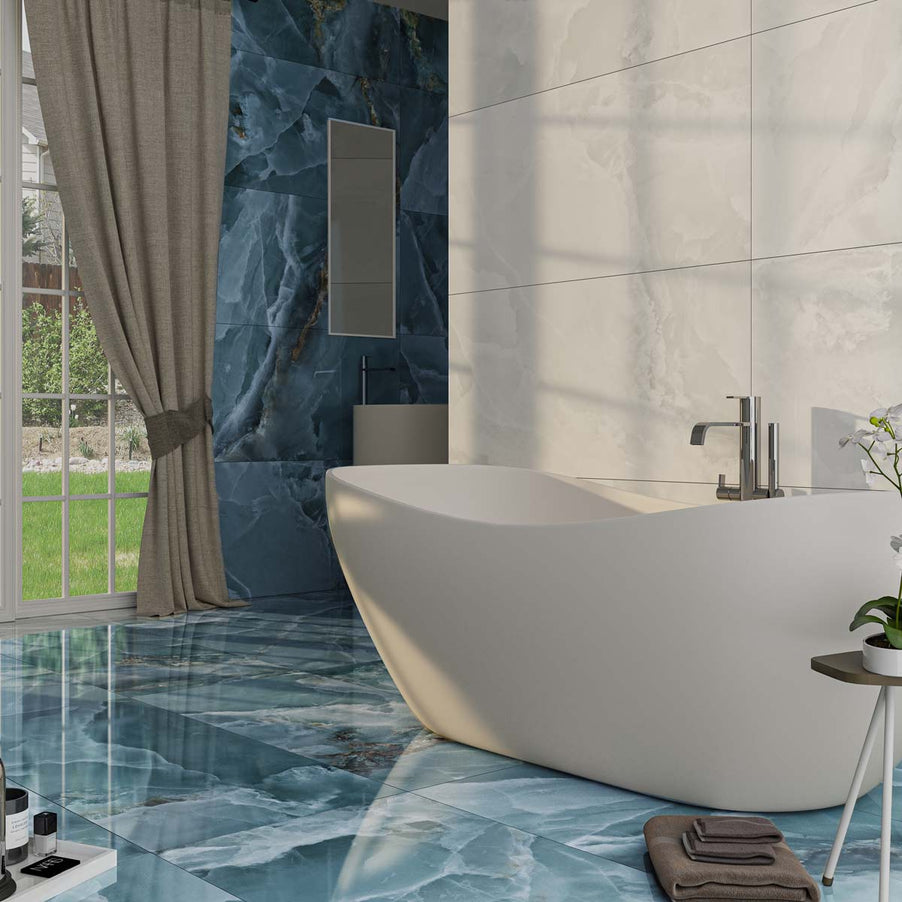 Crystal Navy Blue Marble tile 60x120cm as bathroom floor tiles and bathroom wall tiles. White bathroom tiles to the wall housing a white, freestanding bath. Large window to the anterior with draping grey curtain. Wood stool with potted plant next to the bath, brown towels piled on the floor.