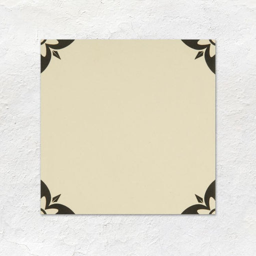 Beige square with black floral corners on a textured white background