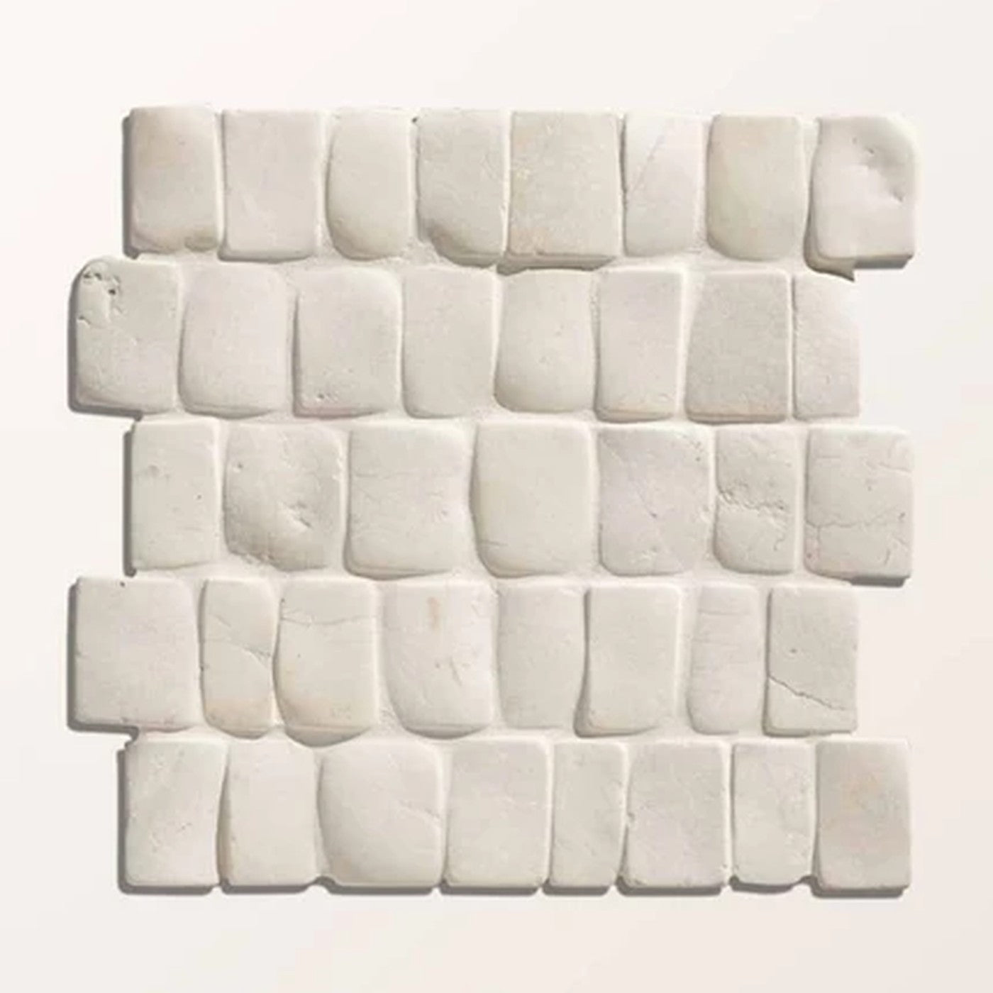Image of White rectangular mosaic wall tiles arranged in staggered rows, showing a textured, stone-like surface.