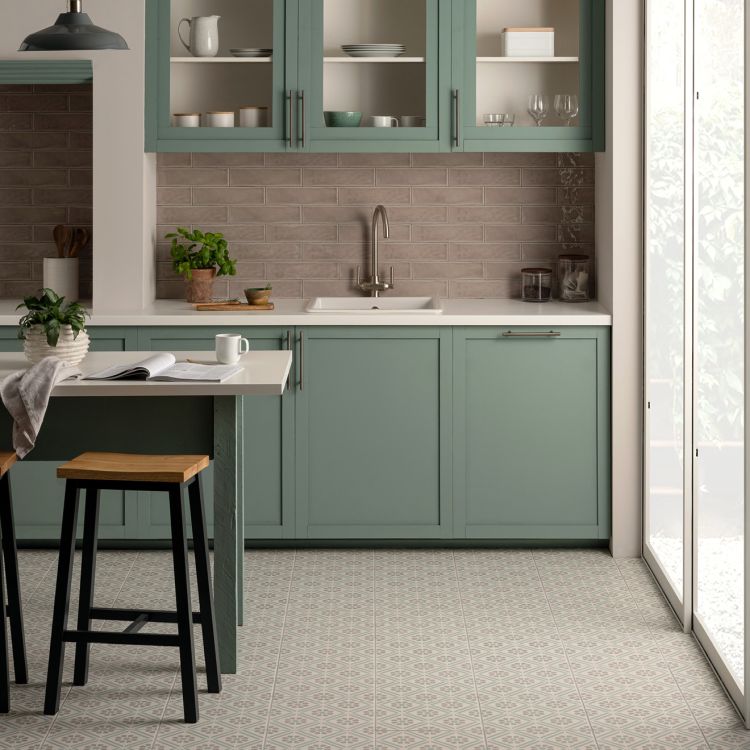Image of Modern kitchen with green cabinets, white countertops, and a tiled floor.