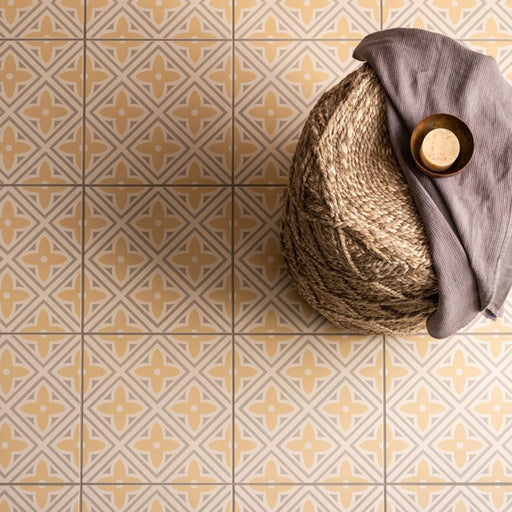 Decorative tiles with geometric pattern and woven basket on a matching floor.
