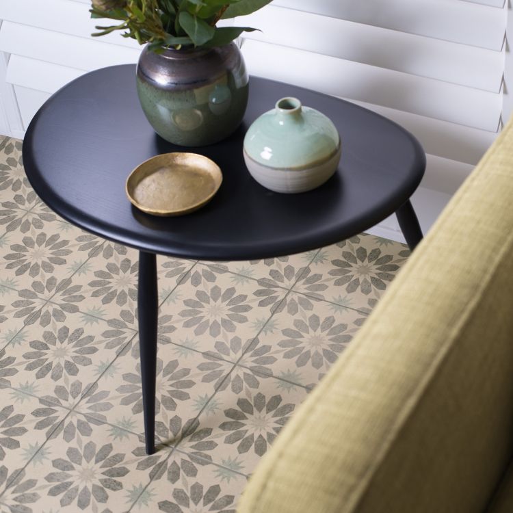 Image of Black side table with decorative items on a patterned floor