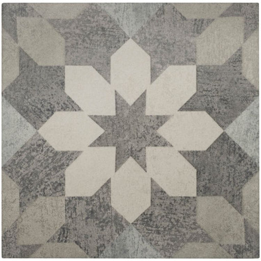 Geometric patterned rug with white and gray shapes