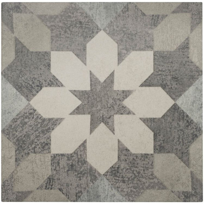 Geometric patterned rug with white and gray shapes