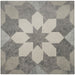 Geometric patterned rug with white and gray shapes