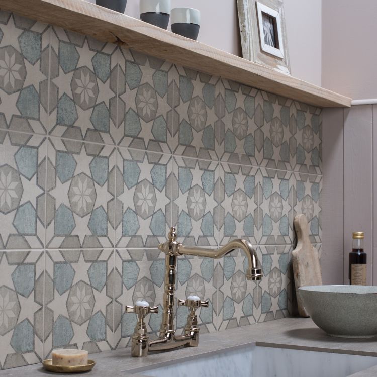 Image of Kitchen sink area with patterned tiles and modern faucet