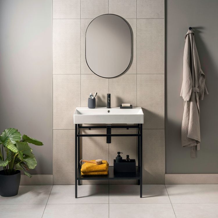 Image of Bathroom setup with a sink, mirror, and towel hanging on a wall.