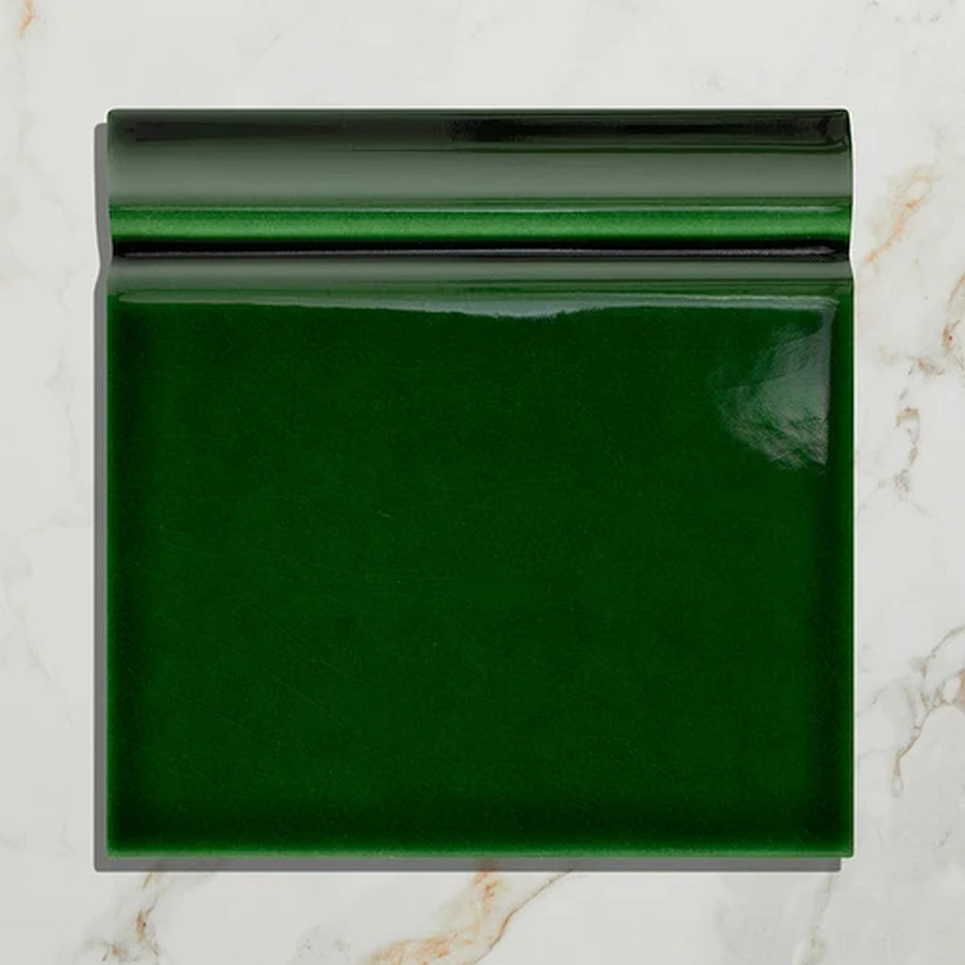 Image of Green rectangular tile on a marble background