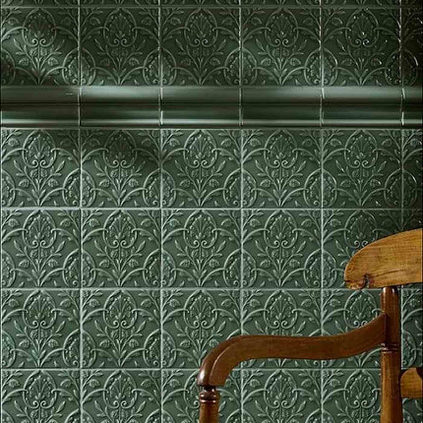 Image of Dark green Victorian-style embossed tiles with an ornate vine pattern and decorative moulding.