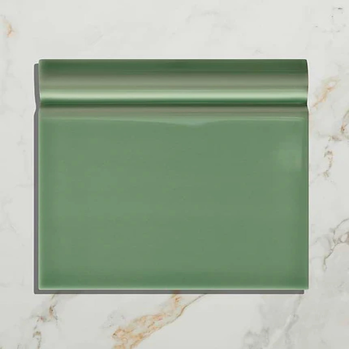 Image of Green rectangular tile on a marble surface