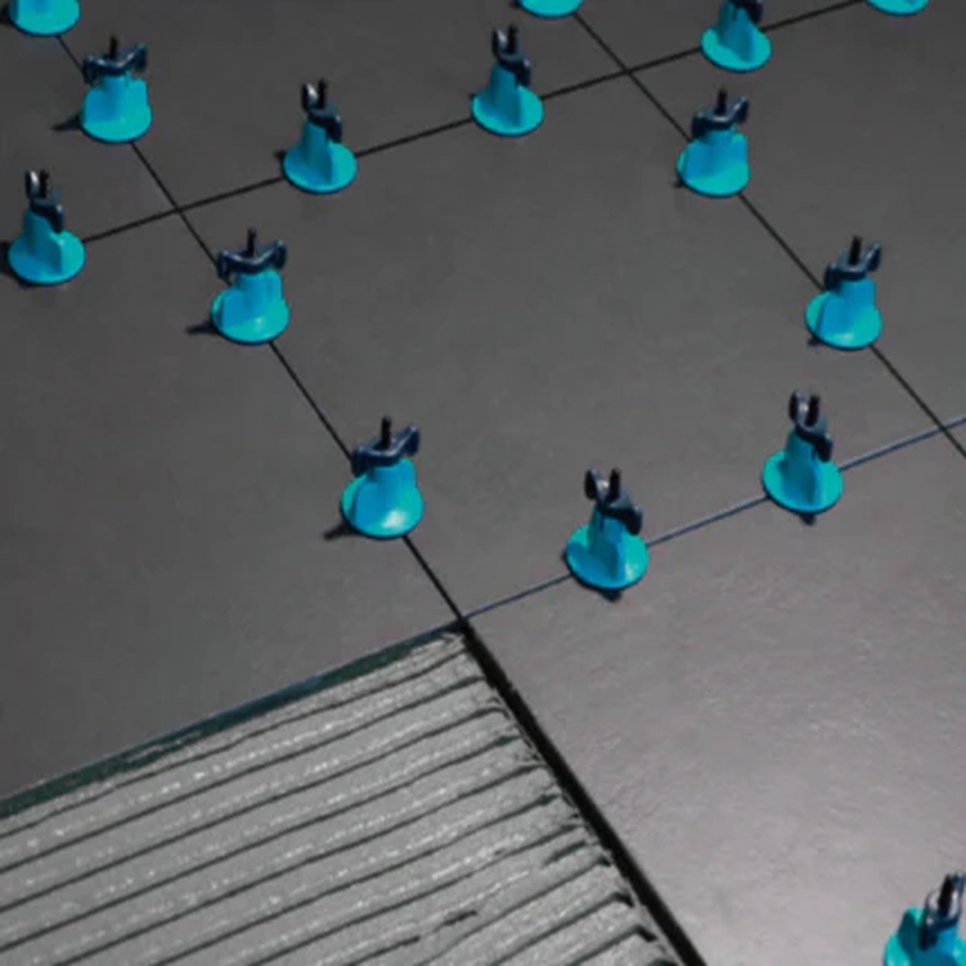 Image of Blue plastic anchors on a tiled floor