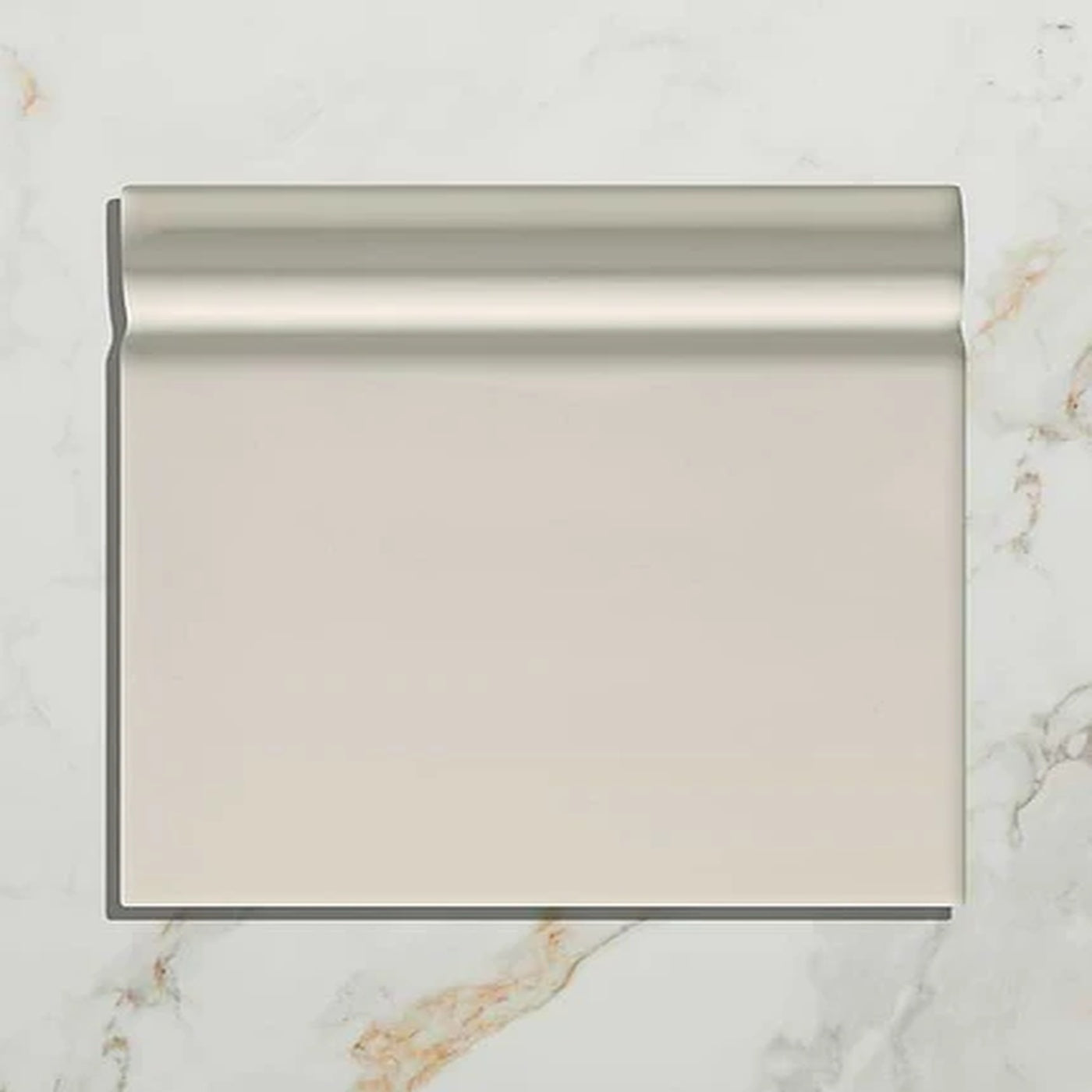 Image of Small white wall tile on a marble surface