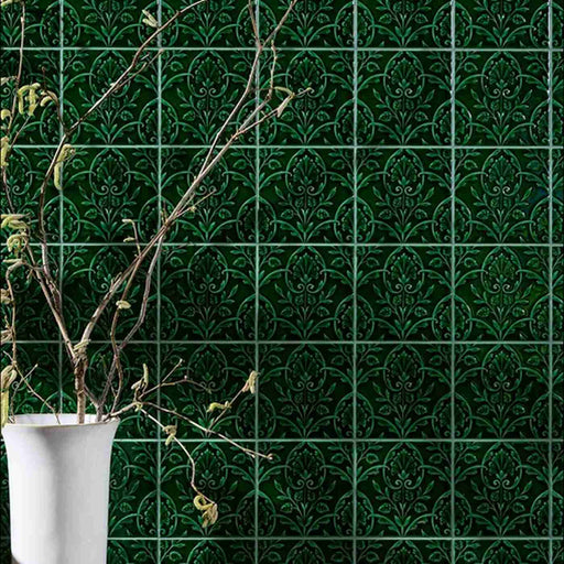 Wall tiled with small green patterned Victorian style tiles 