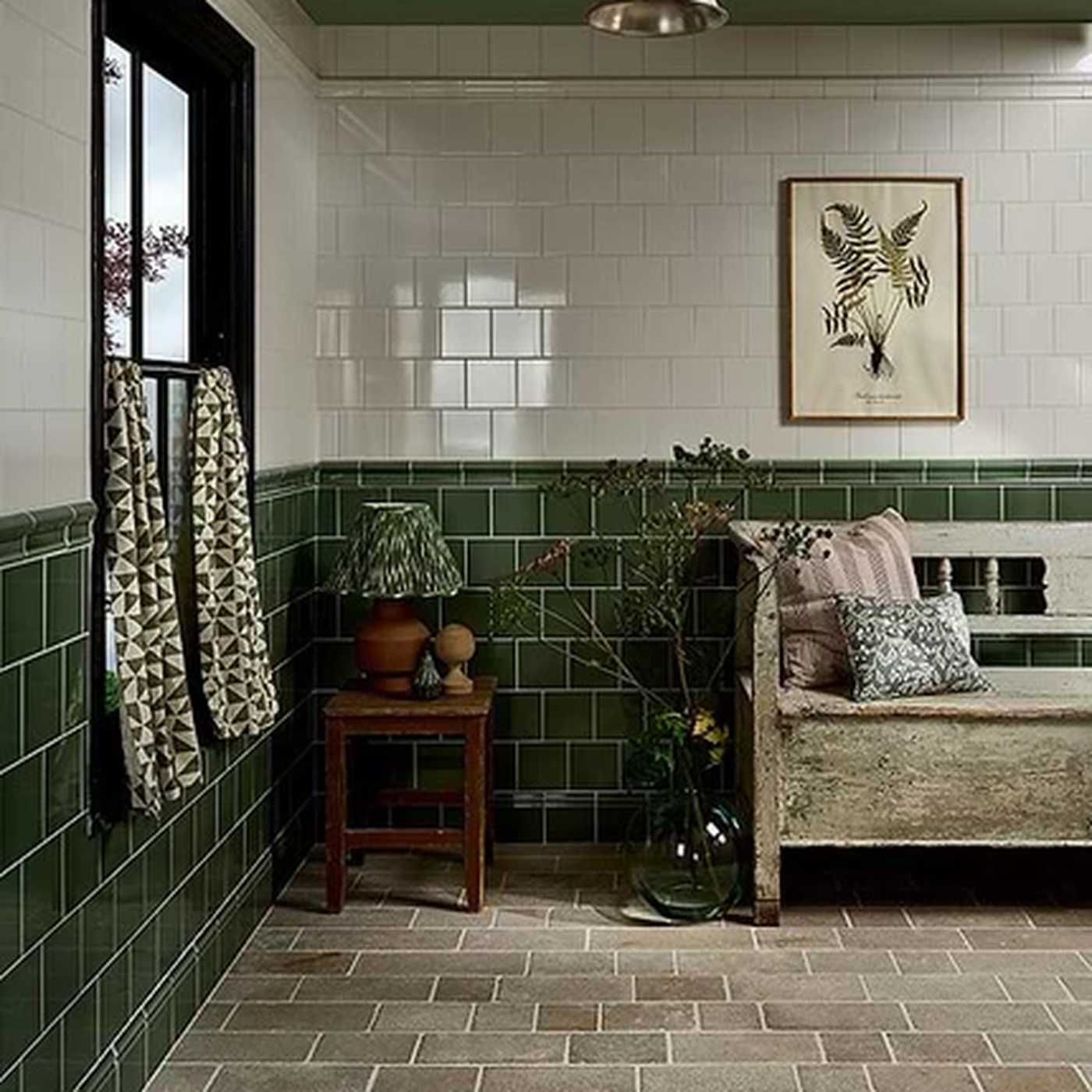 Image of Nook with green tiled walls, a bench, and decorative items.