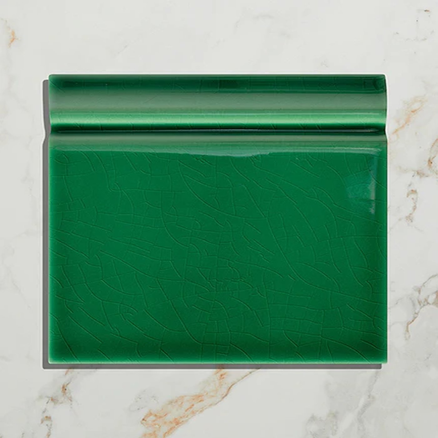Image of Green ceramic tile on a marble background