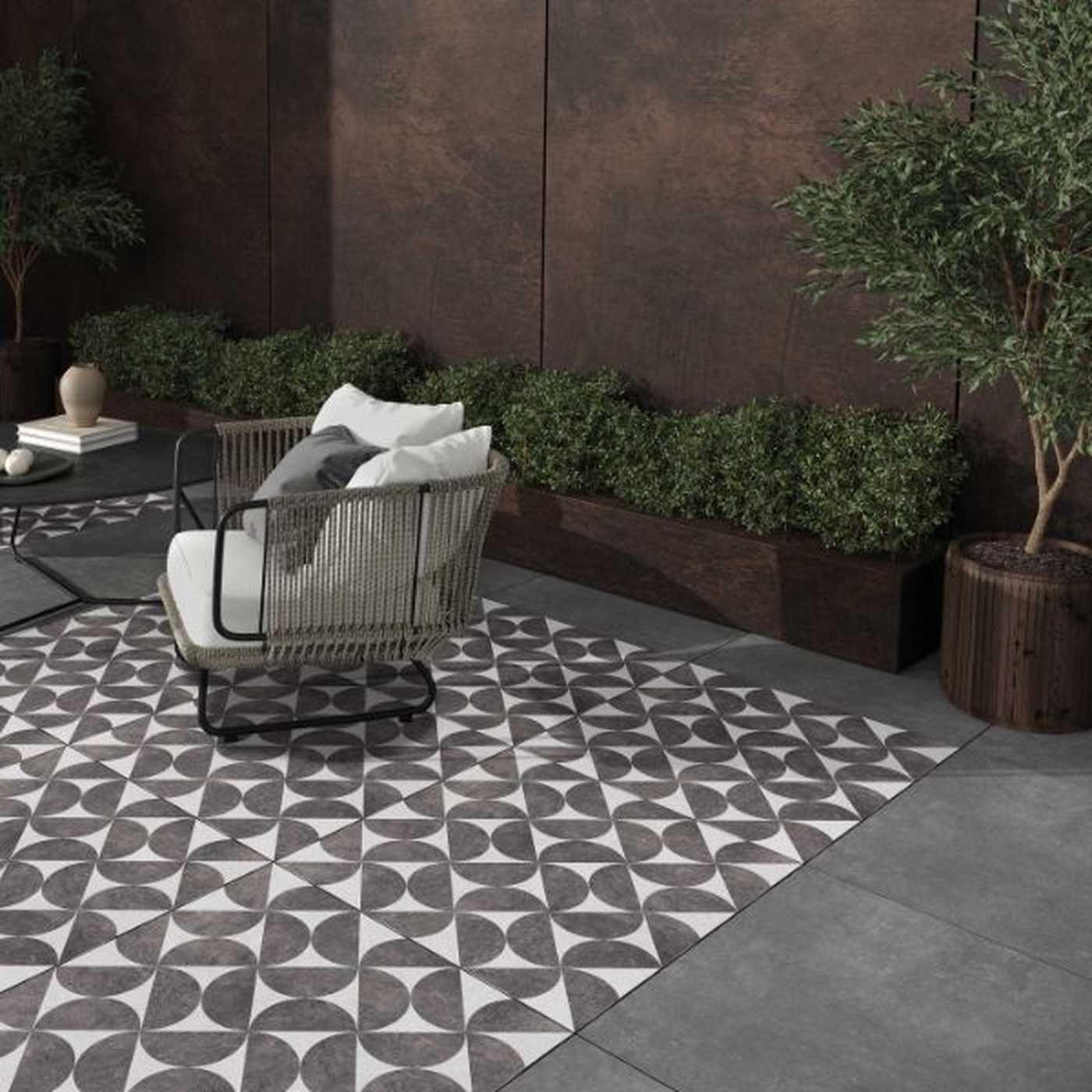 Image of Outdoor floor tile with a grey geometric pattern made of repeating circular and triangular shapes arranged in a symmetrical grid