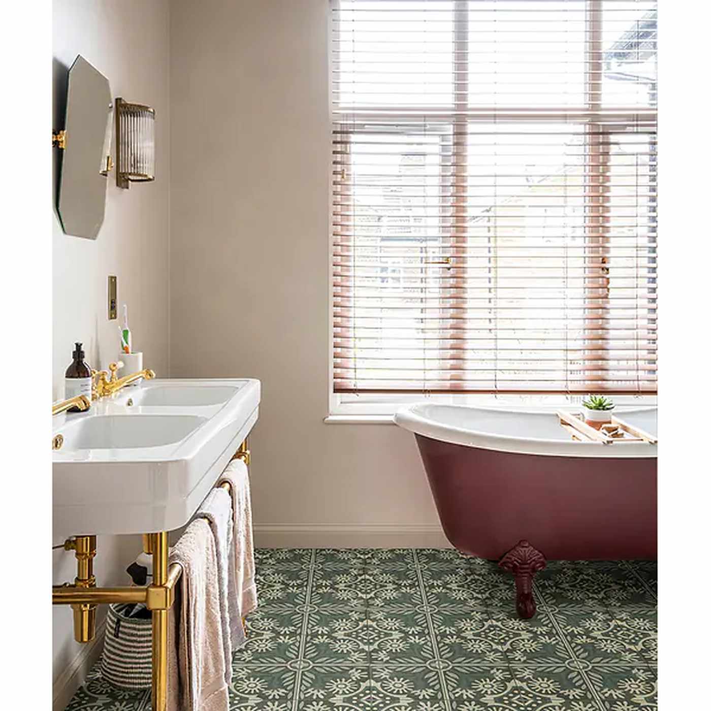 Image of Bathroom with a freestanding bathtub, sink, and decorative tiles.