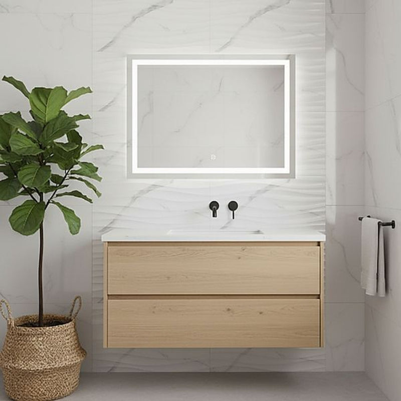Image of Modern wall-mounted oak-effect bathroom vanity with an illuminated rectangular mirror, marble-look tiled wall, and a potted indoor plant in a bright minimalist bathroom.