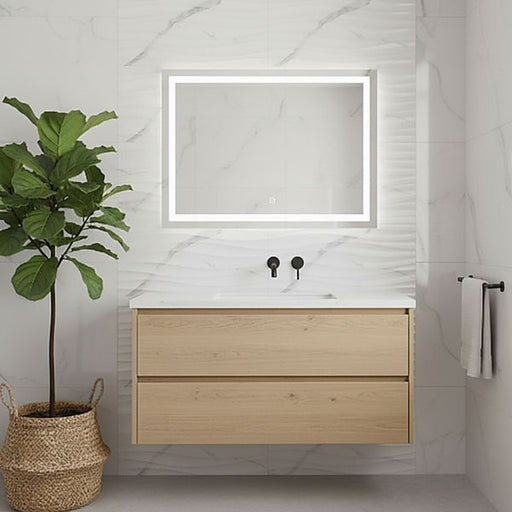 Modern wall-mounted oak-effect bathroom vanity with an illuminated rectangular mirror, marble-look tiled wall, and a potted indoor plant in a bright minimalist bathroom.