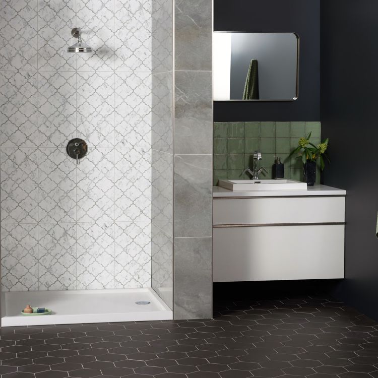 Image of Modern bathroom with tiled shower, vanity, and mirror.