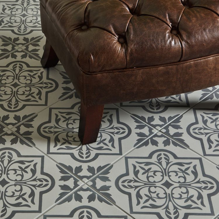 Brown leather ottoman on a patterned tile floor