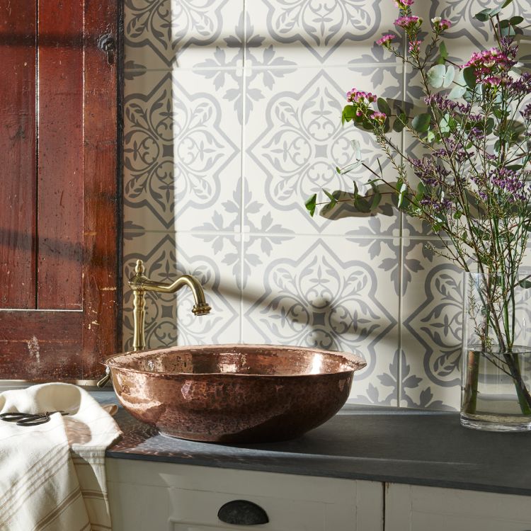 Image of Bathroom with a copper sink and decorative tiles