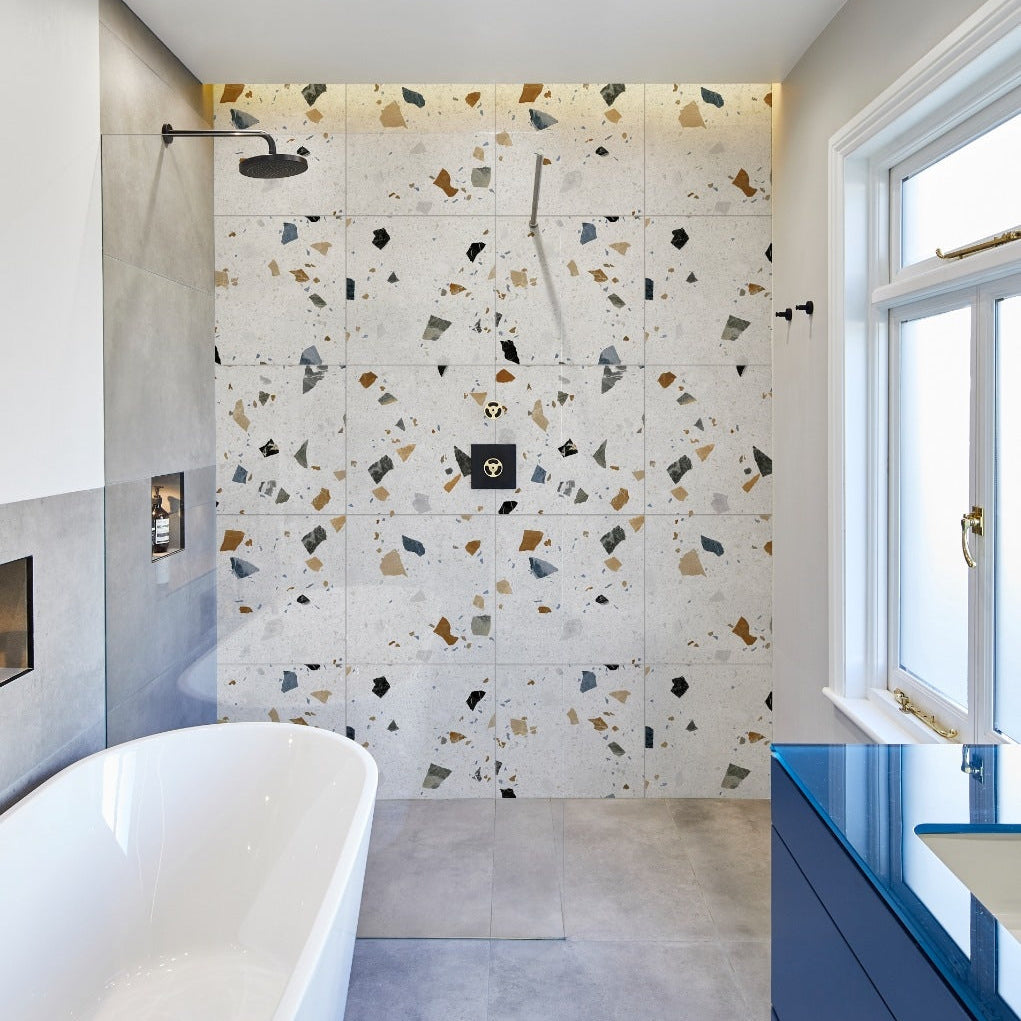 Image of Modern bathroom with terrazzo tiles and a freestanding bathtub.